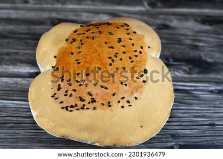 Egyptian Mahlab bread, puff thin, crispy and delicious with black seed baraka seeds on top, made of flour, dry yeast, milk, eggs, sugar, salt, black seeds, warm water, with anything or on its own Royalty-Free Stock Photo #2301936479