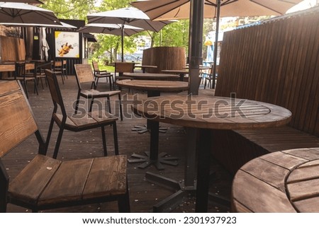 Empty cafe terrace with tables and chairs. Exterior of cafe restaurant. 