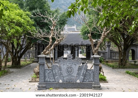 View of the entrance to temple of Suoi Tien in the Red River Delta of Ninh Binh, Vietnam (text on stone translates to: Temple and citadel of the holy spirit Suoi Tien)