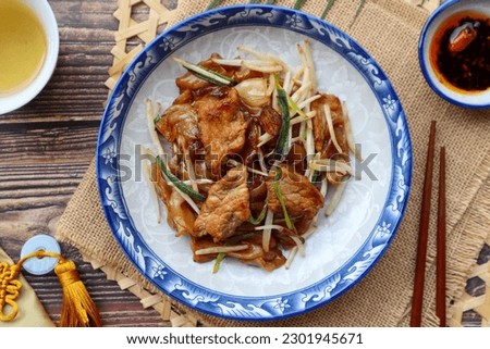 Beef Chow fun - Stir fried flat noodle with bean spout and scallion, famous Chinese food at top view  Royalty-Free Stock Photo #2301945671