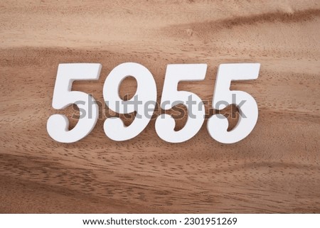White number 5955 on a brown and light brown wooden background.