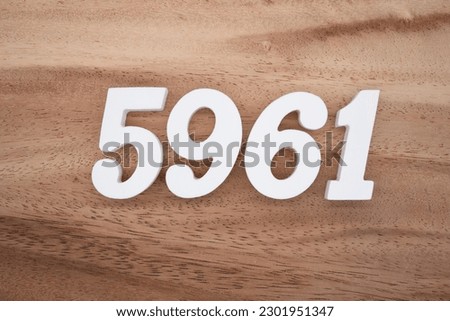White number 5961 on a brown and light brown wooden background.