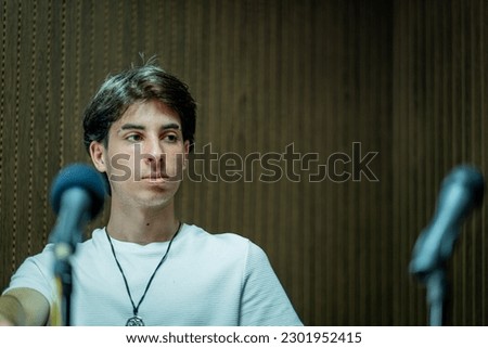 Radio announcer in their studio filled with microphones. Concept of podcast.