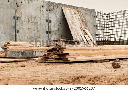 Monolithic reinforced concrete work at the construction site. Boards for the construction of formwork. Erection and reinforcement of reinforced concrete walls of the building Royalty-Free Stock Photo #2301966237