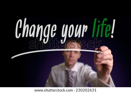 A businessman writing Change Your Life on a screen. Business Concept.