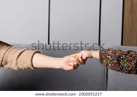 Mother and little daughter holding hands. adult and child hand. Family connection, Trust and support.