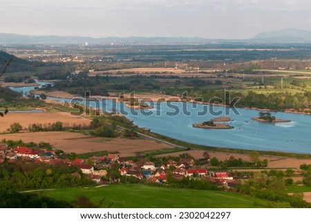 Photography of the beautiful Transylvanian landscape with countryside crops, lake and picturesque villages. Photography was taken from a higher ground using telephoto lens.