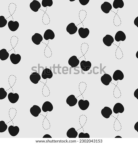 A pattern of black cherries on a grey background