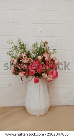 vase of roses and white walls