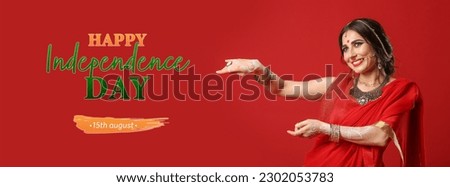 Beautiful Indian woman in sari and text HAPPY INDEPENDENCE DAY on red background