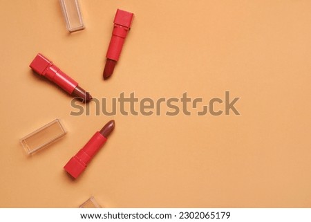 Red lipsticks on beige background
