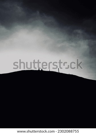 Two people sitting at the top of the Austrian mountain in black and white