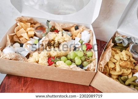 The concept of delivery or picnic. Delicious snack on party or picnic time. Meat and cheese. Italian style banquet. High quality photo