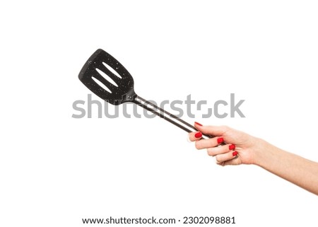 Female hand hold spatula. Isolated on a white background . High quality photo