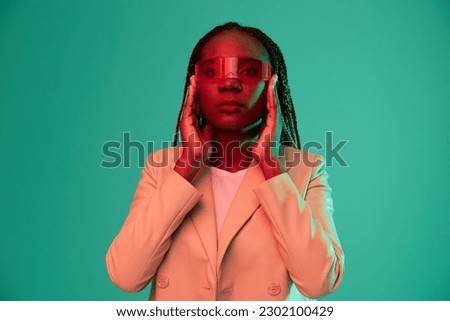 African american woman smile and fashion wearing glasses green background in neon light color mixed light, bright color dancing, futuristic party. Beauty African American woman with pigtails emotions.
