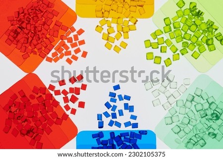 transparent colored plastic resins in with color sample plates in laboratory Royalty-Free Stock Photo #2302105375