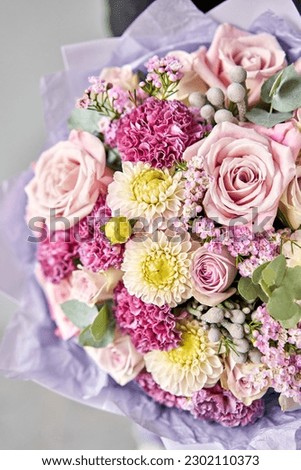 Beautiful bouquet of mixed flowers in woman hand. Floral shop concept . Beautiful fresh cut bouquet. Flowers delivery