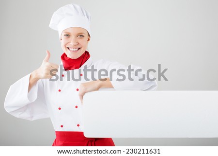 Chef Sign. Woman cook / baker looking over paper sign billboard. 