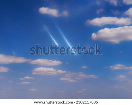Two meteorites fly in the daytime sky. Bright meteors in daylight. Beautiful shooting stars between the clouds.