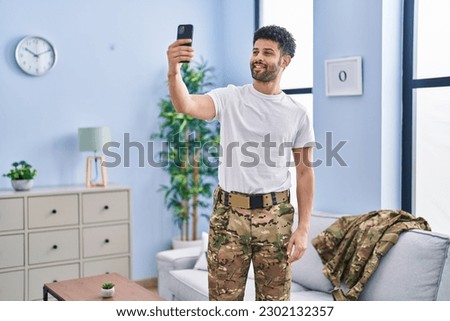 Young arab man army soldier making selfie by the smartphone at home
