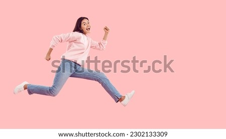 Seasonal discounts. Funny energetic young woman rushes to shopping center in hurry for crazy discounts on sales. Woman in casual clothes running isolated on pink background. Web banner. Copy space. Royalty-Free Stock Photo #2302133309