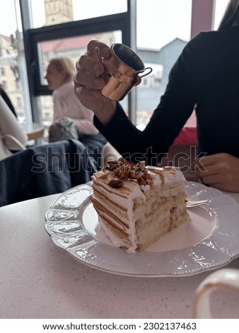 A girl holding syrup for cake