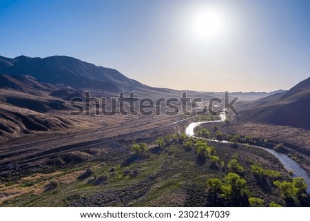 Aerial View of at the Truckee river, Interstate 80 and railroad tracks east of the Reno, Sparks Nevada area on a late springtime morning. Royalty-Free Stock Photo #2302147039