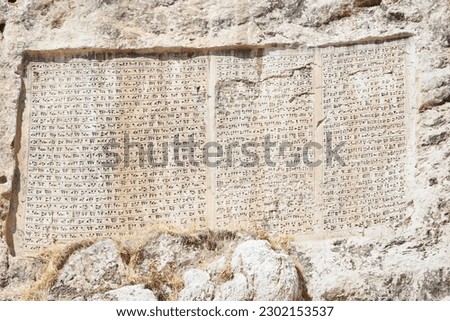 An inscription on the rockface of Van Castle left by legendary monarch Xerxes the Great in the 5th century BC Royalty-Free Stock Photo #2302153537