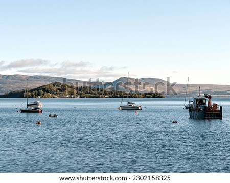 Boats on Loch Lomond, with Inchmurrin Island and Conic Hill behind. Viewed from the western shore of the loch. Loch Lomond and the Trossachs National Park, Scotland. Royalty-Free Stock Photo #2302158325
