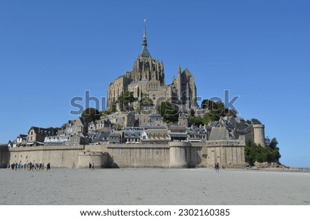 Impressive gothic monastery Mont Saint Michel in Normandy, Northern France, Europe. Unesco heritage. Medieval churhc on the island. Summer sunny day, clear sky.