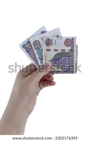 Hand Holding paper Egyptian Money Royalty-Free Stock Photo #2302176395