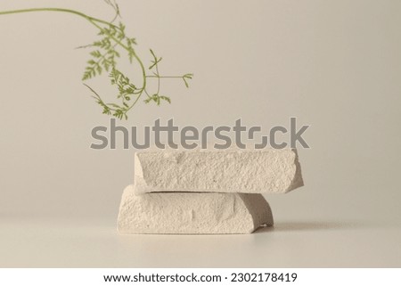 Stack of stones platform podium on beige light background. Minimal empty display product presentation scene. Royalty-Free Stock Photo #2302178419