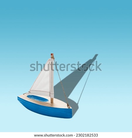 A wooden boat with a sail on a blue background
