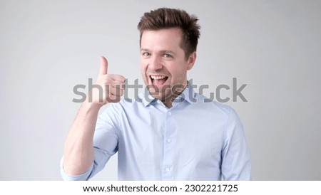 The European young man gives a thumbs up, approving the choice