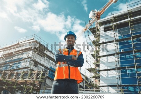 Engineer, construction and portrait of a black man at building site for development and architecture. Male contractor happy about project management, engineering and safety inspection outdoor in city Royalty-Free Stock Photo #2302260709
