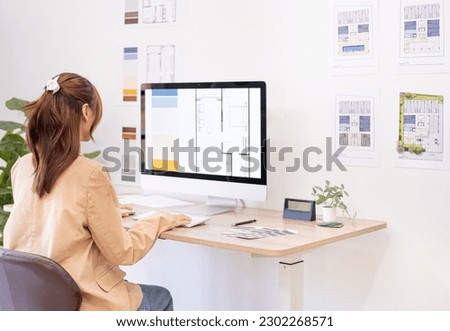 Professional interior designer working in the office, Young asian female architect working on business of Real estate project , sketching on a house plan choosing swatches and material.