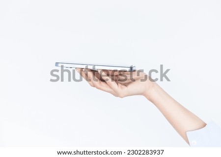Woman hand holding an empty smartphone isolated on white background, Female waitress hand using smart phone, Concept of digital service .