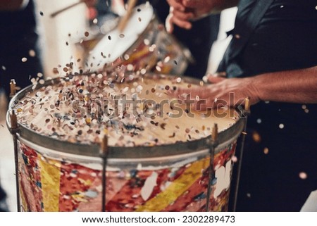 Music, drums and carnival with a person playing an instrument during a festival in rio de janeiro. Hands, party and brazil with a musician, performer or artist banging on a drum to create a beat Royalty-Free Stock Photo #2302289473