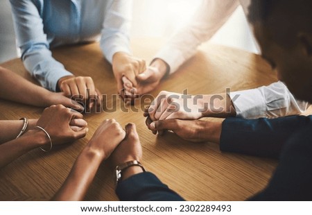 Unity, compassion and people holding hands by a table at a group counseling or therapy session. Gratitude, trust and friends in a circle for praying together for religion, community and connection. Royalty-Free Stock Photo #2302289493