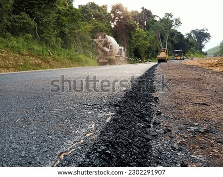 asphalting of a new road on the south latitude line in the afternoon