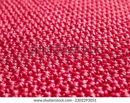 Knitted fabric of pink, crimson color close-up as a background. High quality photo