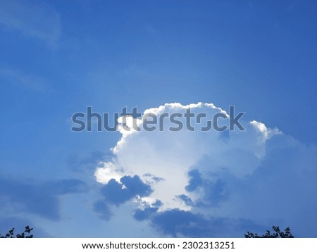 A picture of a white cloud on the blue sky in Asia.