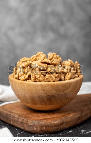 Walnut. Walnut kernel in wooden bowl. Superfood. Vegetarian food concept. Healthy snacks. Close up Royalty-Free Stock Photo #2302345503