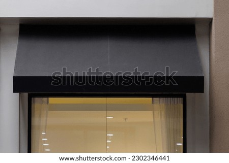 black awning canvas of the store window. sunblind roof.