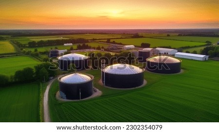 Green biogas plant storage tanks. Aerial view over biogas plant and farm in green fields. Renewable energy from biomass. Modern agriculture concept. Royalty-Free Stock Photo #2302354079