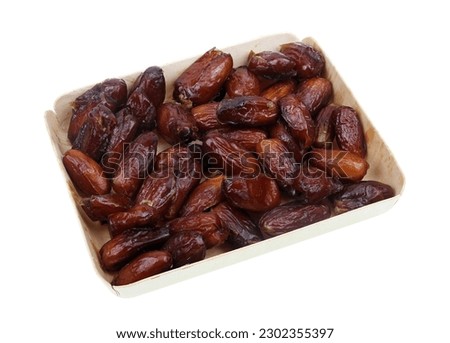 Dried sweet Egyptian dates in a box isolated on white