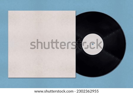 Close-up on a Vinyl record and its cover mockup with copy space on blue background.