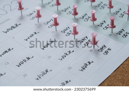 4 day work week printed calendar with pink pins on three days off in week weekend days four day working week concept. Modern approach doing business short workweek. Effectiveness of employees Royalty-Free Stock Photo #2302375699