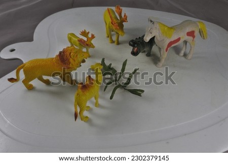Close up photo of animal toy: lion, horse, deer, camel
