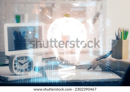 Drawing bulb over woman's hands taking notes background. Concept of idea. Double exposure